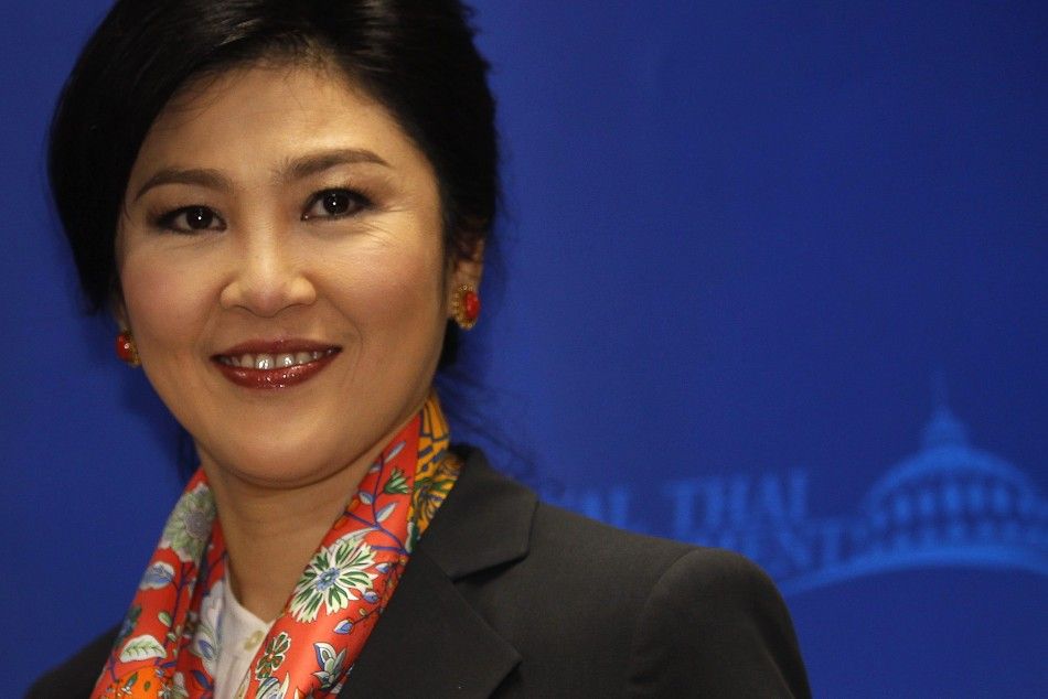 Thailands Prime Minister Yingluck Shinawatra smiles as she arrives to address reporters in Bangkok May 7, 2014. A Thai court found Yingluck guilty of violating the constitution on Wednesday and said she had to step down, throwing the country into further