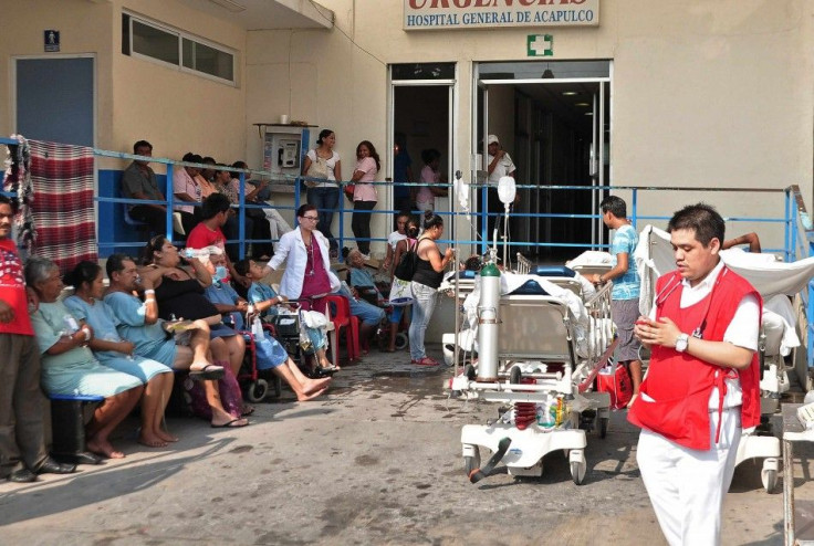 Patients sit together outside a hospital after they were evacuated following an earthquake in Acapulco, in Guerrero state, April 18, 2014. The powerful earthquake struck Mexico on Friday, shaking buildings in the capital and sending people running out int
