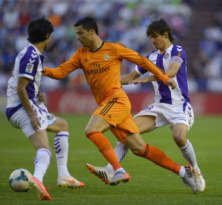 Real Madrid's Ronaldo challenges Valladolid's Alvaro Rubio and Marc Valiente during their Spanish First Division soccer match at Zorrilla Stadium in Valladolid