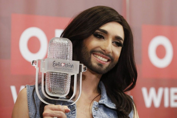 Austria's Conchita Wurst poses with her trophy after a news conference in Vienna