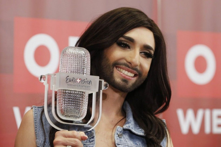 Austria's Conchita Wurst poses with her trophy after a news conference in Vienna
