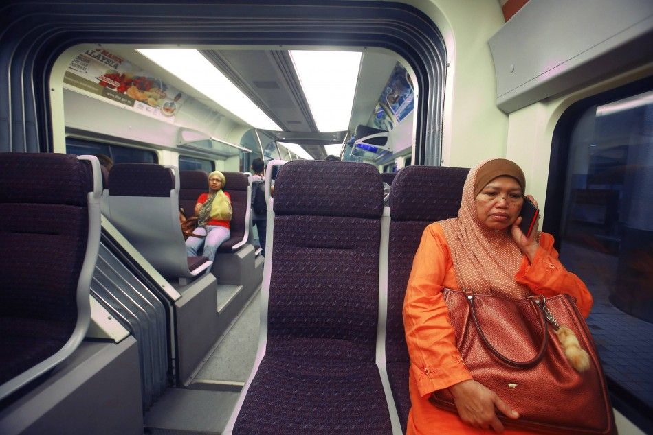 A women sits inside the new Express Rail Link ERL train enroute from KL Sentral to KLIA2 airport, April 30, 2014. The International Civil Aviation Organisation ICAO has given the green light for Kuala Lumpur International Airport 2 KLIA2, the countr