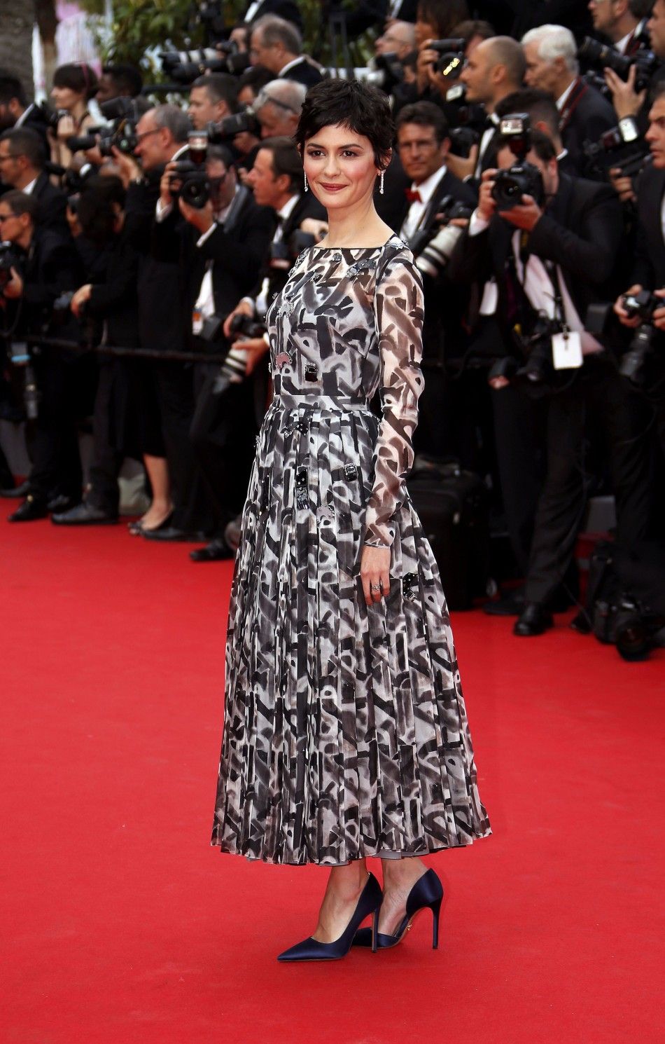 Actress Audrey Tautou poses on the red carpet as she arrives for the opening ceremony of the 67th Cannes Film Festival in Cannes