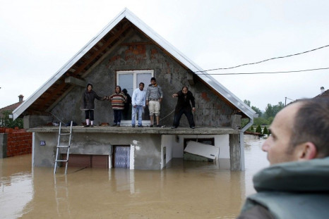 REFILE - CORRECTING DIRECTION OF TOWN FROM BELGRADE  People stand on a terrace of their flooded house as they wait before being evacuated in the town of Obrenovac, southwest of Belgrade May 16, 2014. The heaviest rains and floods in 120 years have hit Bos