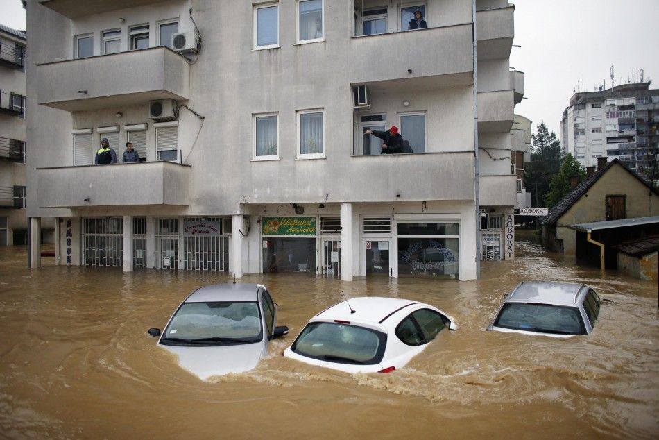 REFILE - CORRECTING DIRECTION OF TOWN FROM BELGRADE  People stand in their apartments as they wait to be evacuated in the flooded town of Obrenovac, southwest of Belgrade, May 17, 2014. Emergency services pulled seven dead bodies from flooded homes in Bos