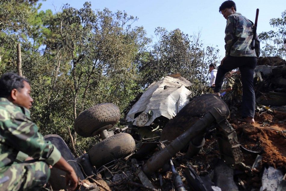 Rescue workers search an air force plane crash site near Nadee village, in Xiang Khouang province in the north of the country May 17, 2014. The Laotian air force plane with at least 14 people on board crashed on Saturday, a defence ministry source said, a