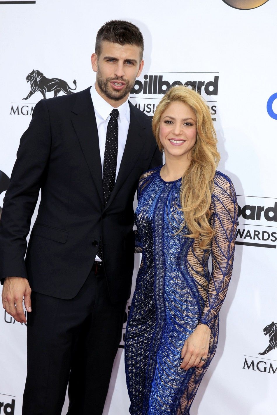 Singer-songwriter Shakira and professional soccer player Gerard Pique arrive at the 2014 Billboard Music Awards in Las Vegas, Nevada May 18, 2014.   REUTERSL.E. Baskow 