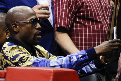 May 9, 2014; Los Angeles, CA, USA; Floyd Mayweather Jr. takes a selfie during game three of the second round of the 2014 NBA Playoffs at Staples Center.