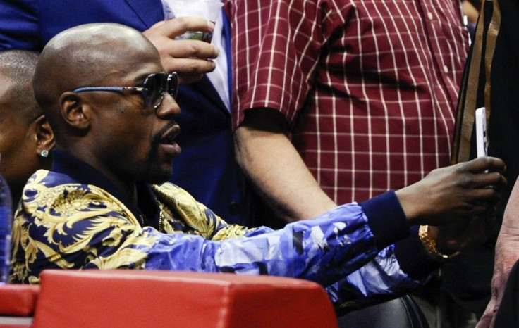 May 9, 2014; Los Angeles, CA, USA; Floyd Mayweather Jr. takes a selfie during game three of the second round of the 2014 NBA Playoffs at Staples Center.