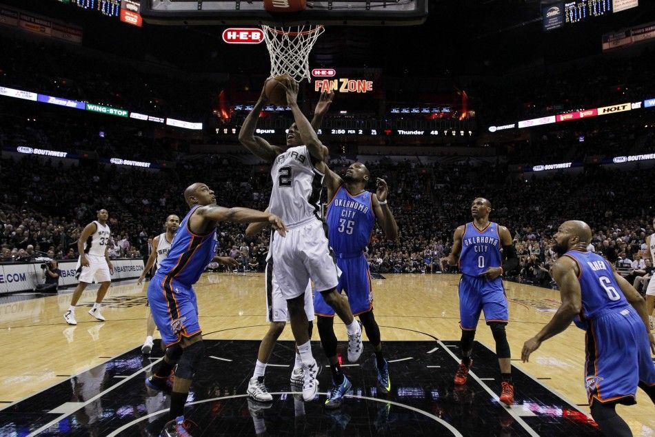 May 19, 2014 San Antonio, TX, USA San Antonio Spurs forward Kawhi Leonard 2 shoots the ball as Oklahoma City Thunder forward Caron Butler left and Kevin Durant 35 defend in game one of the Western Conference Finals in the 2014 NBA Playoffs at ATT