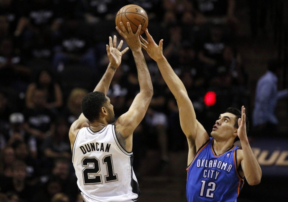 May 19, 2014 San Antonio, TX, USA San Antonio Spurs forward Tim Duncan 21 shoots the ball over Oklahoma City Thunder center Steven Adams 12 in game one of the Western Conference Finals in the 2014 NBA Playoffs at ATT Center. 