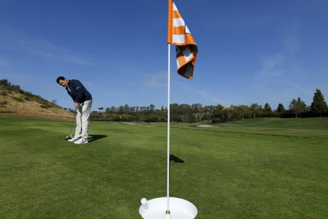 Dave Cordero of TaylorMade putts into a 15-inch inch hole at his company&#039;s golf facility in Carlsbad, California