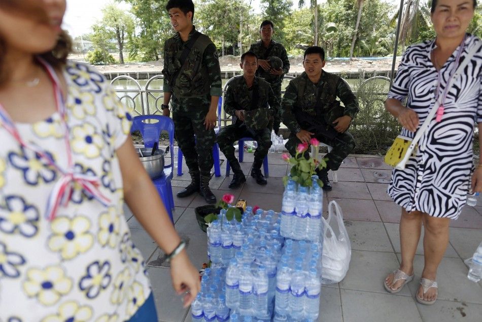 Anti-government protesters deliver food and water to Thai soldiers at a checkpoint near pro-government quotred shirtquot supporters encampment in suburbs of Bangkok May 20, 2014. 