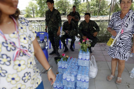 Anti-government protesters deliver food and water to Thai soldiers at a checkpoint near pro-government &quot;red shirt&quot; supporters encampment in suburbs of Bangkok May 20, 2014. 