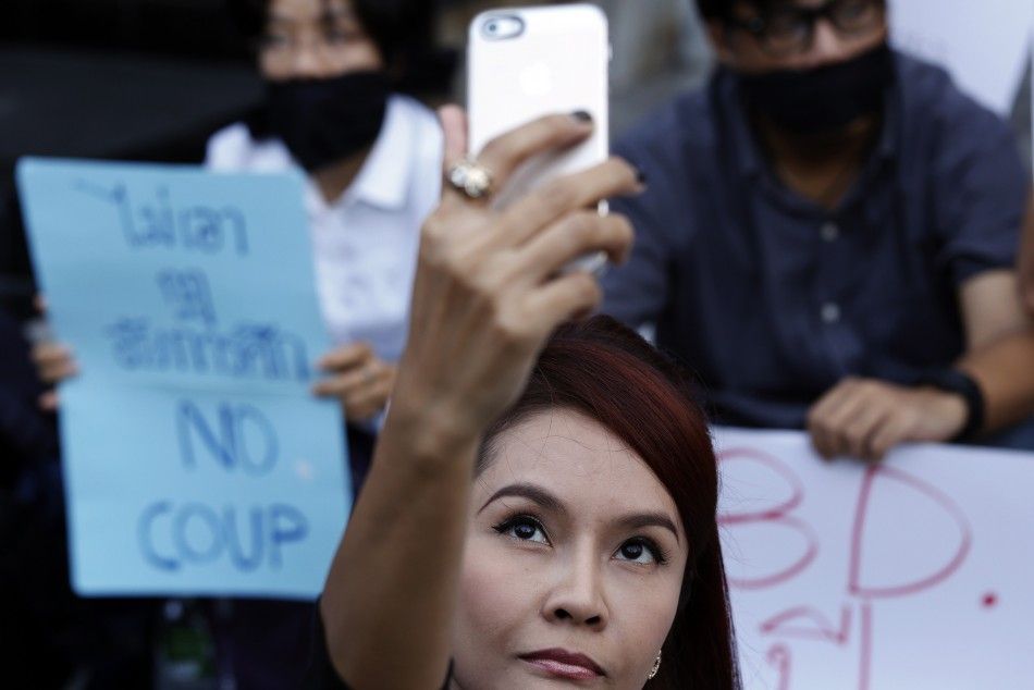 A woman takes a quotselfiequot photograph as activists attend a small protest against the declaration of martial law and the armys involvement in politics, in central Bangkok May 20, 2014. 