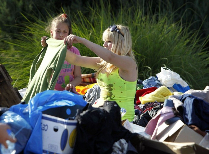 A woman looks for clothes among a donated pile during heavy floods in Bosanski Samac May 19, 2014. Bosnia said on Monday that more than a quarter of its 4 million people had been affected by the worst floods to hit the Balkans in living memory, comparing 