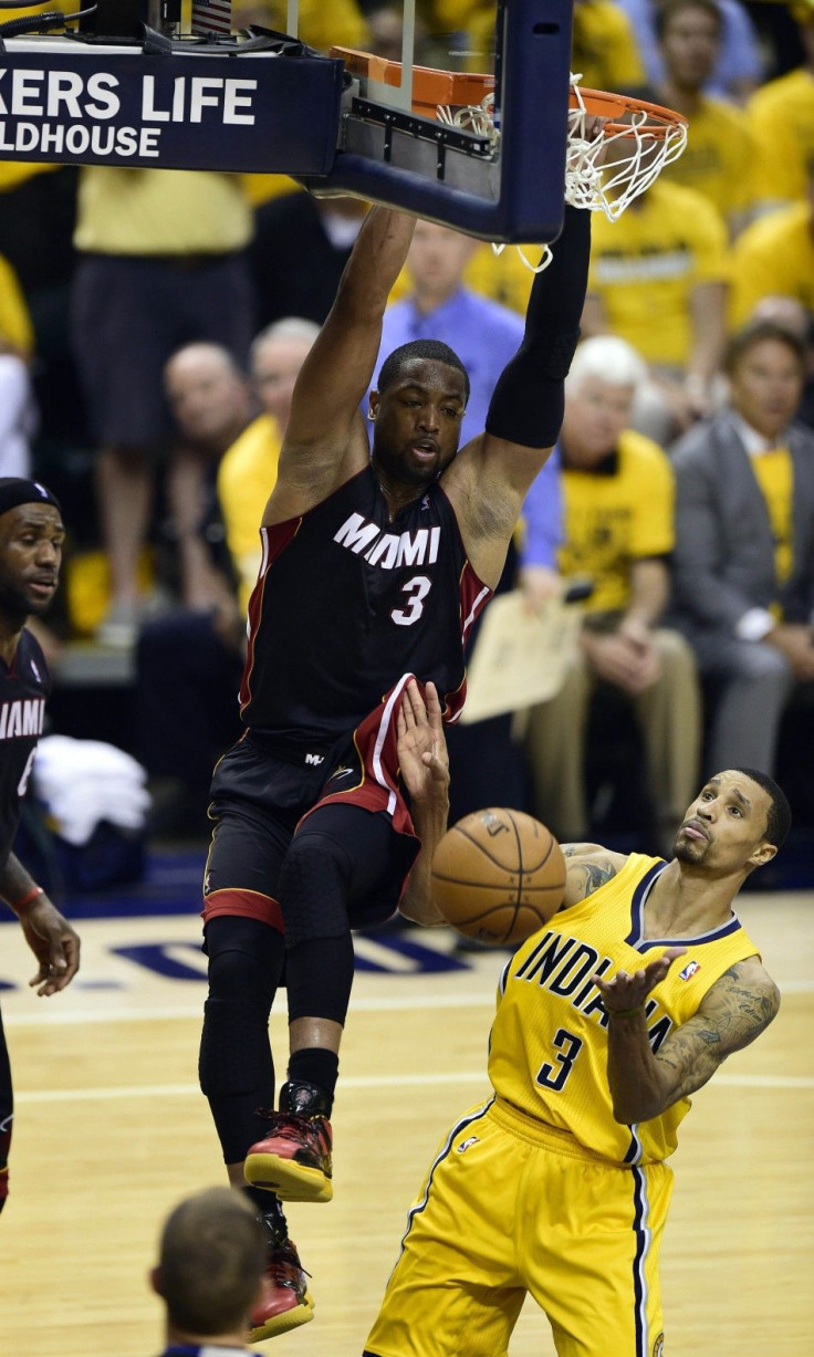May 20, 2014; Indianapolis, IN, USA; Miami Heat guard Dwyane Wade (3) dunks the ball over Indiana Pacers guard George Hill (3) during the second half of game two of the Eastern Conference Finals of the 2014 NBA Playoffs at Bankers Life Fieldhouse. The Mia