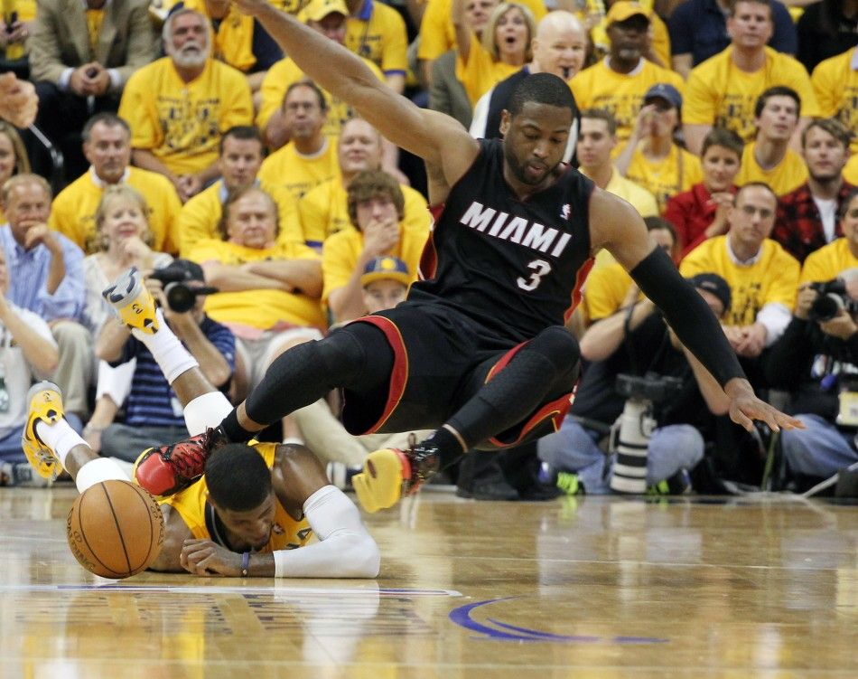 May 20, 2014 Indianapolis, IN, USA Indiana Pacers forward Paul George 24 gets hit in the head by Miami Heat guard Dwayne Wade 3 during a scramble for a loose ball in game two of the Eastern Conference Finals of the 2014 NBA Playoffs at Bankers Life 
