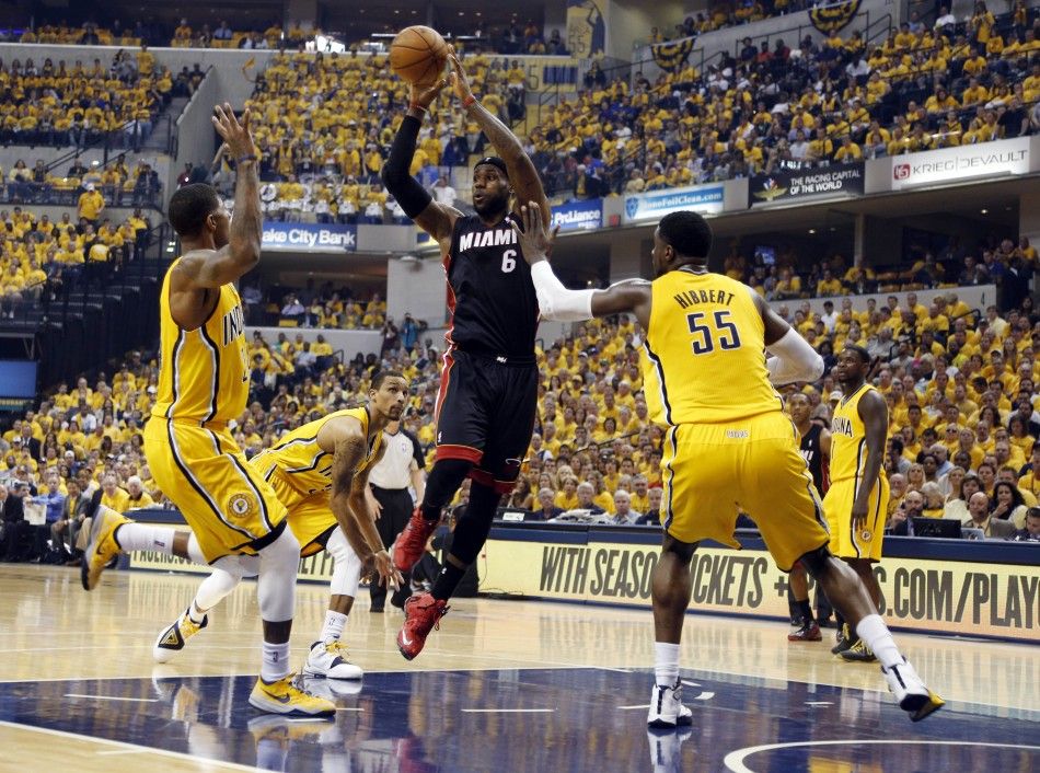 Miami Heat forward LeBron James 6 makes a pass against Indiana Pacers forward Paul George 24 and center Roy Hibbert 55 