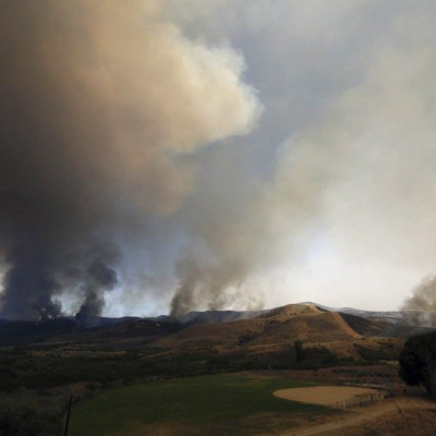 The Las Pulgas Fire burns near an athletics field at Camp Pendleton, California in this May 16, 2014 handout photo from the USMC. The Las Pulgas Fire is one of four fires at Camp Pendleton Marine Base north of San Diego which  prompted evacuations of seve