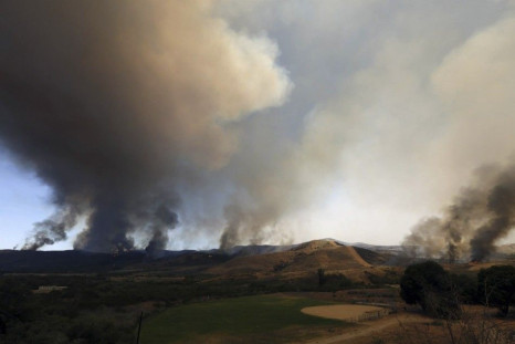 The Las Pulgas Fire burns near an athletics field at Camp Pendleton, California in this May 16, 2014 handout photo from the USMC. The Las Pulgas Fire is one of four fires at Camp Pendleton Marine Base north of San Diego which  prompted evacuations of seve