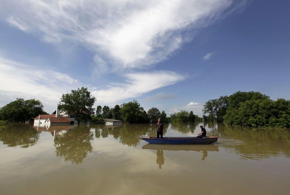 Villagers paddle during heavy floods in the village of Prud, May 20, 2014. Communities in Serbia and Bosnia battled to protect towns and power plants on Monday from rising flood waters and landslides that have devastated swathes of both countries and kill
