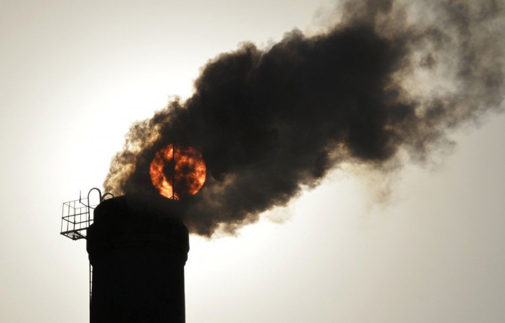 The sun is seen behind smoke billowing from a chimney of a heating plant in Taiyuan, Shanxi province in this December 9, 2013 file photo. 