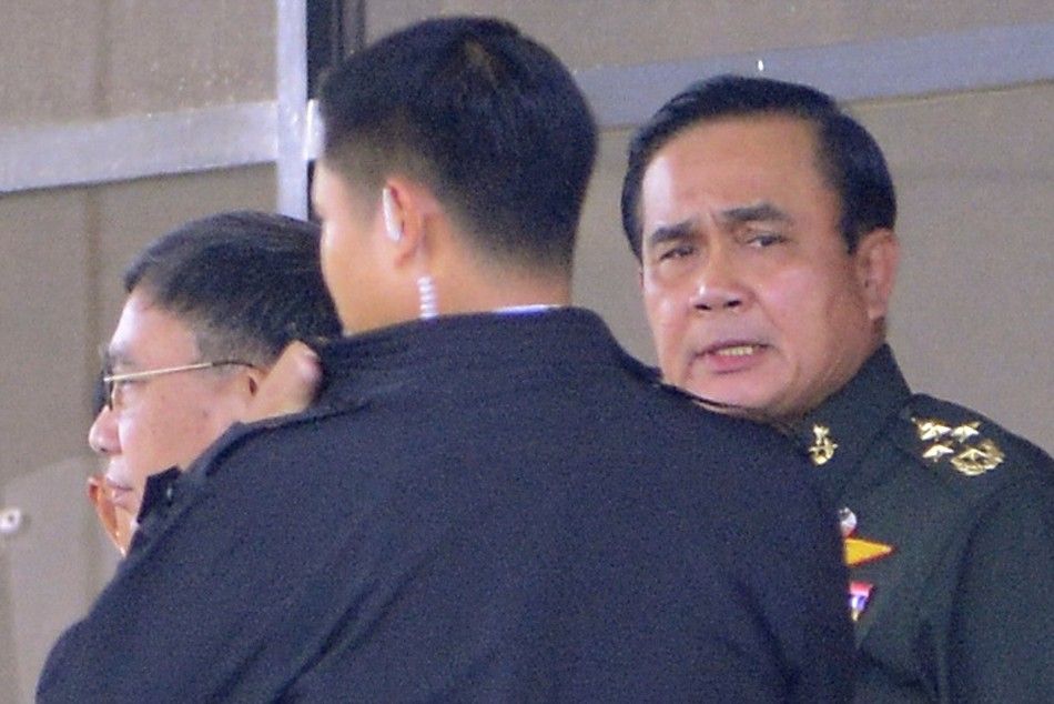 Thailands army chief General Prayuth Chan-ocha R leaves the Army Club after a meeting with all rival factions in central Bangkok May 22, 2014. Prayuth took control of the government in a coup on Thursday saying the army had to restore order and push th