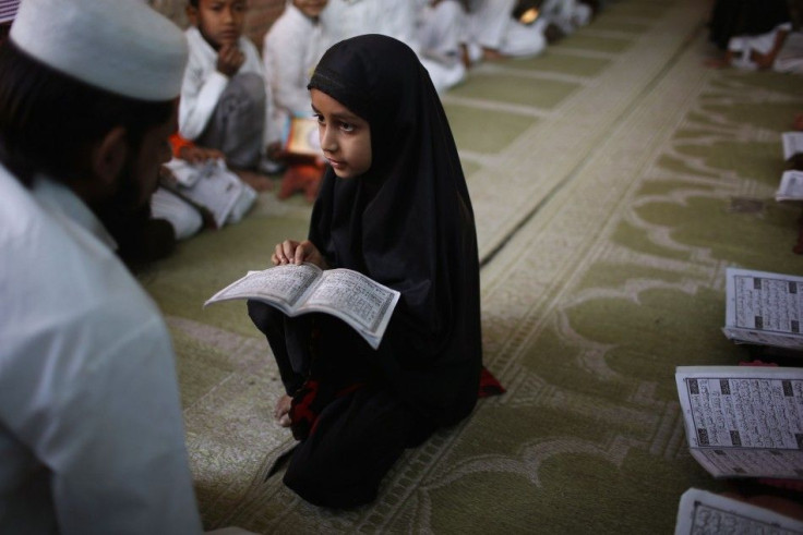 A Muslim girl studies at a Madrassa, or religious school, in the Muslim dominated Johapura area in Ahmedabad