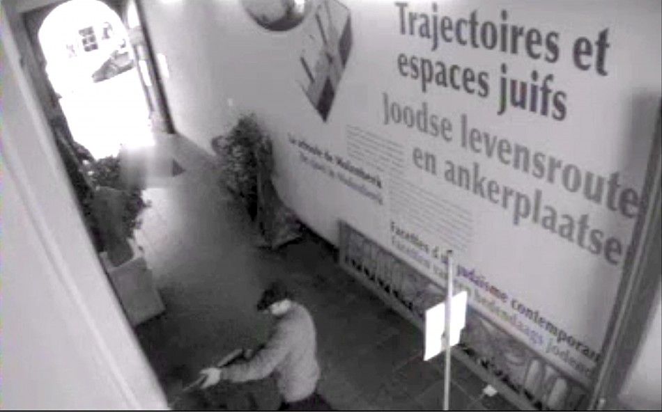 A man is seen holding a weapon inside the Jewish Museum in Brussels, in this still image taken from the video of a security camera and was distributed to the media by the Belgian police on May 25, 2014. Belgian police were hunting on Sunday for an assaila