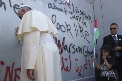 REFILE - REMOVING ADDITIONAL WORD  Pope Francis touches the wall that divides Israel from the West Bank, on his way to celebrate a mass in Manger Square next to the Church of the Nativity in the West Bank city of Bethlehem May 25, 2014. Pope Francis made 