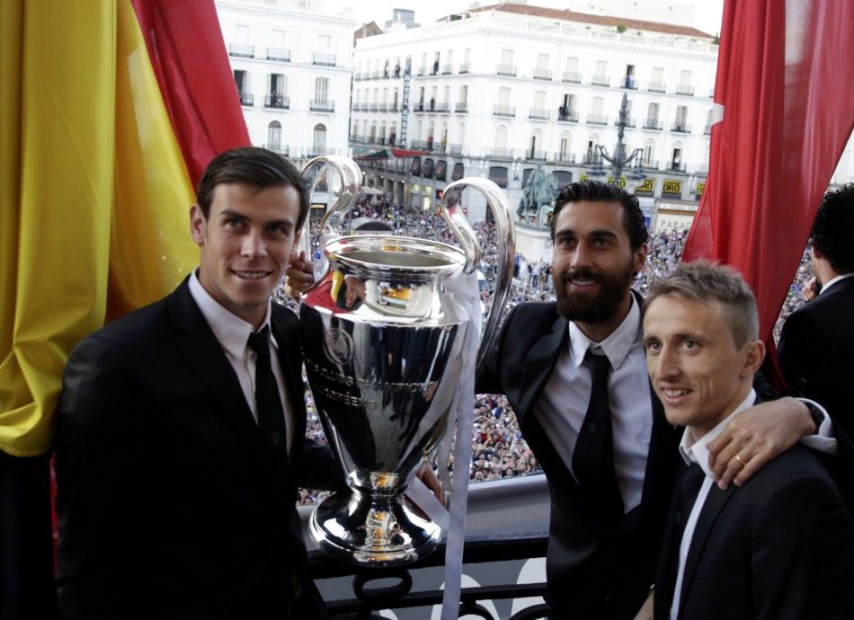 Real Madrids Gareth Bale L, Alvaro Arbeloa C and Luka Modric pose with the Champions League troph