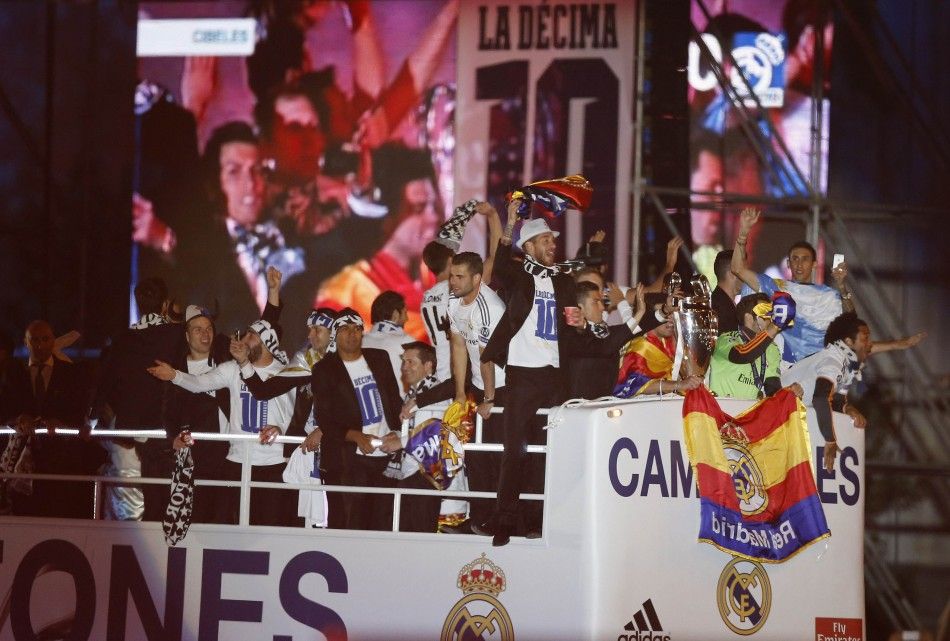 Real Madrid players celebrate on top of an open bus