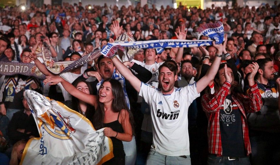 Real Madrids fan cheer during a victory ceremony at Plaza Cibeles