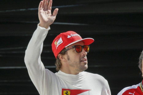 Ferrari Formula One driver Fernando Alonso of Spain waves as he arrives at the third practice session of the Monaco Grand Prix in Monaco May 24, 2014. REUTERS/Robert Pratta
