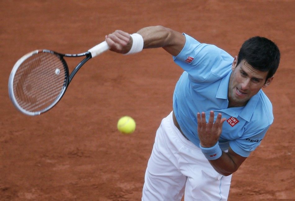 Novak Djokovic of Serbia serves to Joao Sousa of Portugal during their mens singles match at the French Open tennis tournament at the Roland Garros stadium in Paris May 26, 2014. 