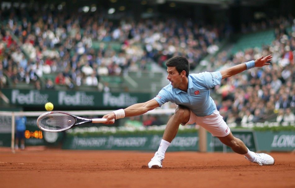 Novak Djokovic of Serbia hits a return to Joao Sousa of Portugal during their mens singles match at the French Open tennis tournament at the Roland Garros stadium in Paris May 26, 2014. 