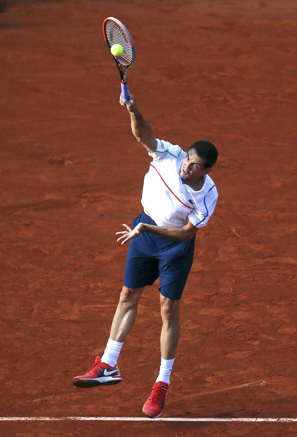 Guillermo Garcia-Lopez of Spain serves to Stan Wawrinka of Switzerland during their mens singles match at the French Open tennis tournament at the Roland Garros stadium in Paris May 26, 2014.