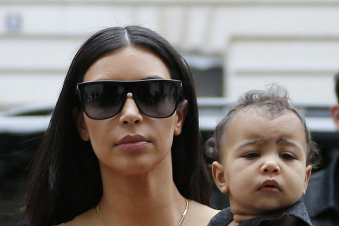 TV Personality Kim Kardashian Holds Her Baby in Her Arms as She Shops in Paris