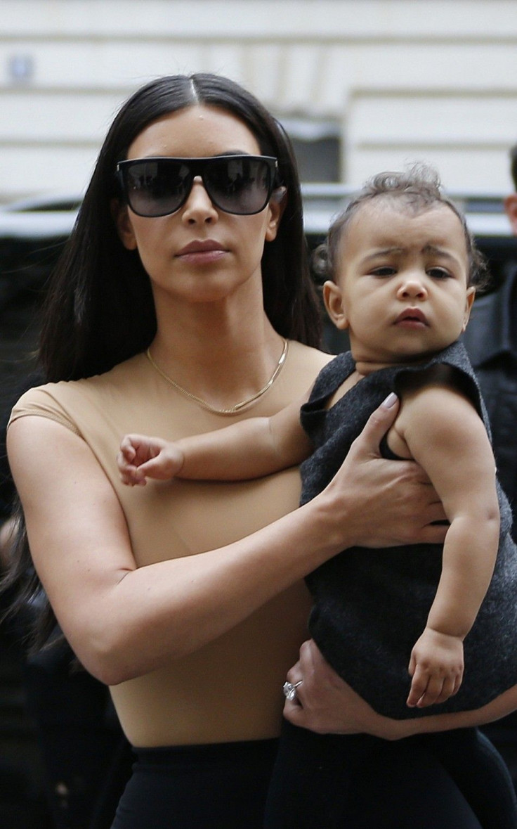TV Personality Kim Kardashian Holds Her Baby in Her Arms as She Shops in Paris