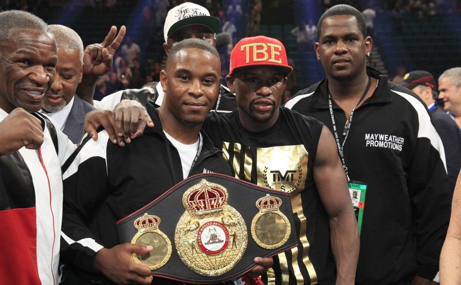 Floyd Mayweather Jr. centre R of the U.S. celebrates his victory over Marcos Maidana of Argentina with members of his camp following a WBCWBA welterweight unification fight at the MGM Grand Garden Arena in Las Vegas, Nevada, May 3, 2014. Mayweather imp