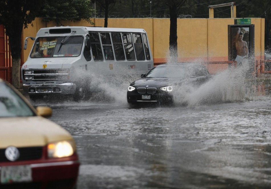 Vehicles drive through a flooded street after torrential rains hit several neighborhoods in Mexico City May 26, 2014. Hurricane Amanda, the first named storm of the Pacific season, moved on Monday losing strength against Mexicos Pacific coast and while s
