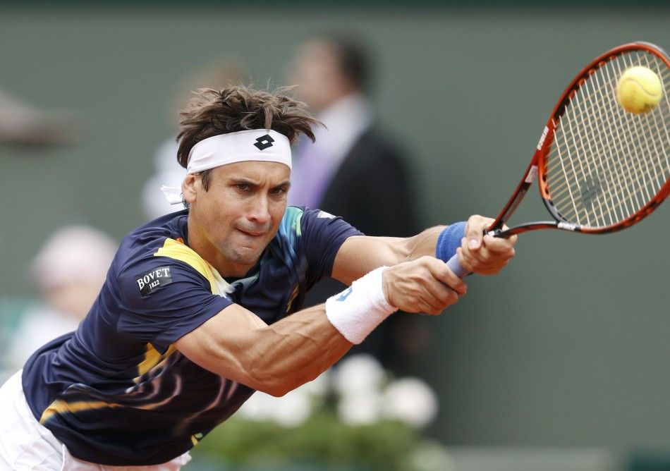 David Ferrer of Spain hits a return to Igor Sijsling of the Netherlands during their mens singles match at the French Open tennis tournament at the Roland Garros stadium in Paris May 27, 2014. 