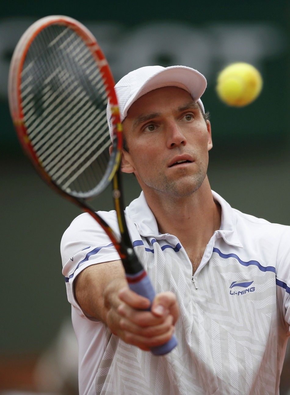 Ivo Karlovic of Croatia hits a return to Grigor Dimitrov of Bulgaria during their mens singles match at the French Open tennis tournament at the Roland Garros stadium in Paris May 27, 2014. 