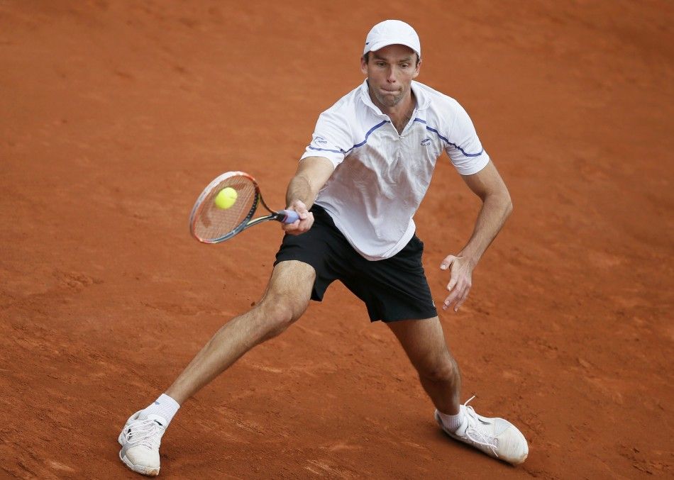 Ivo Karlovic of Croatia returns a forehand to Grigor Dimitrov of Bulgaria during their mens singles match at the French Open tennis tournament at the Roland Garros stadium in Paris May 27, 2014. 
