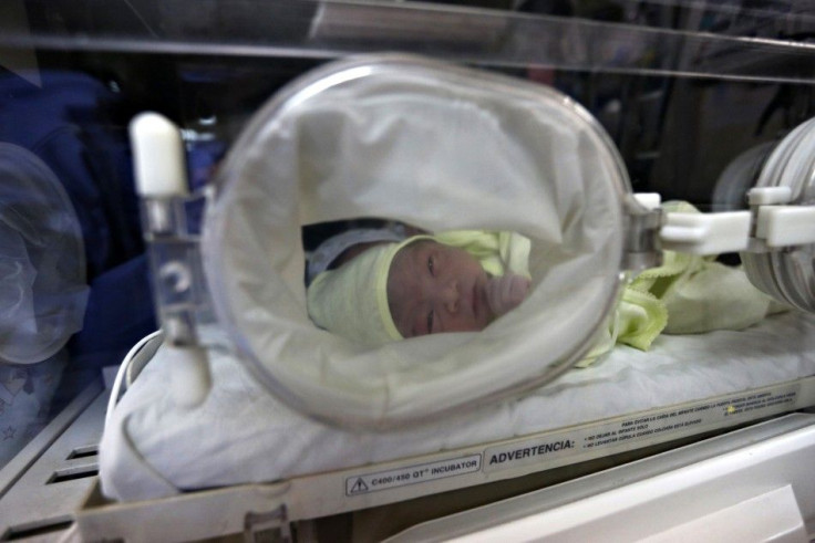 A newborn baby waits for attention at Lima's maternity hospital, May 8, 2014.