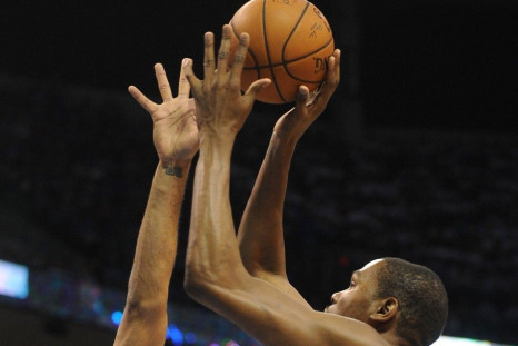 May 27, 2014; Oklahoma City, OK, USA; Oklahoma City Thunder forward Kevin Durant (35) attempts a shot against San Antonio Spurs forward Tim Duncan (21) during the first quarter in game four of the Western Conference Finals of the 2014 NBA Playoffs at Ches