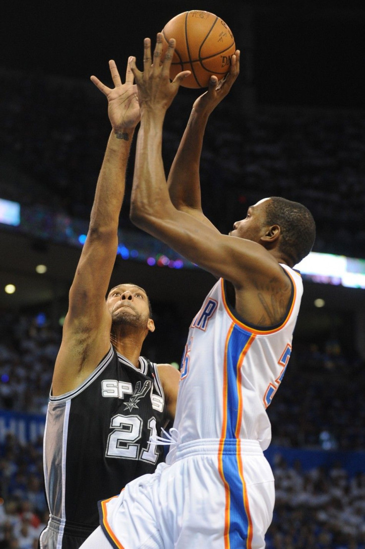 May 27, 2014; Oklahoma City, OK, USA; Oklahoma City Thunder forward Kevin Durant (35) attempts a shot against San Antonio Spurs forward Tim Duncan (21) during the first quarter in game four of the Western Conference Finals of the 2014 NBA Playoffs at Ches