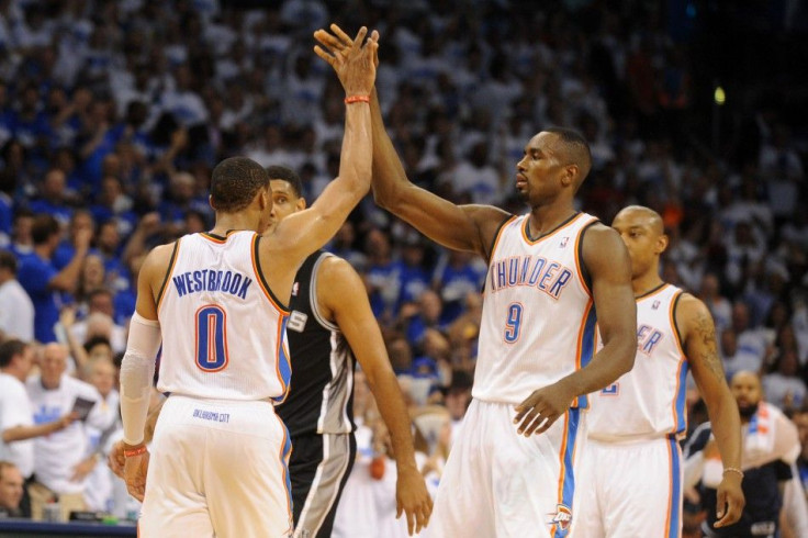 May 27, 2014; Oklahoma City, OK, USA; Oklahoma City Thunder forward Serge Ibaka (9) high fives Oklahoma City Thunder guard Russell Westbrook (0) after a play in action against the San Antonio Spurs in game four of the Western Conference Finals of the 2014