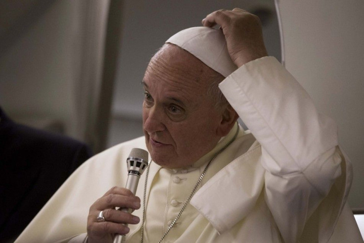 Pope Francis talks to reporters aboard the papal flight on his way back to the Vatican from Jerusalem May 26, 2014. REUTERS/Andrew Medichini